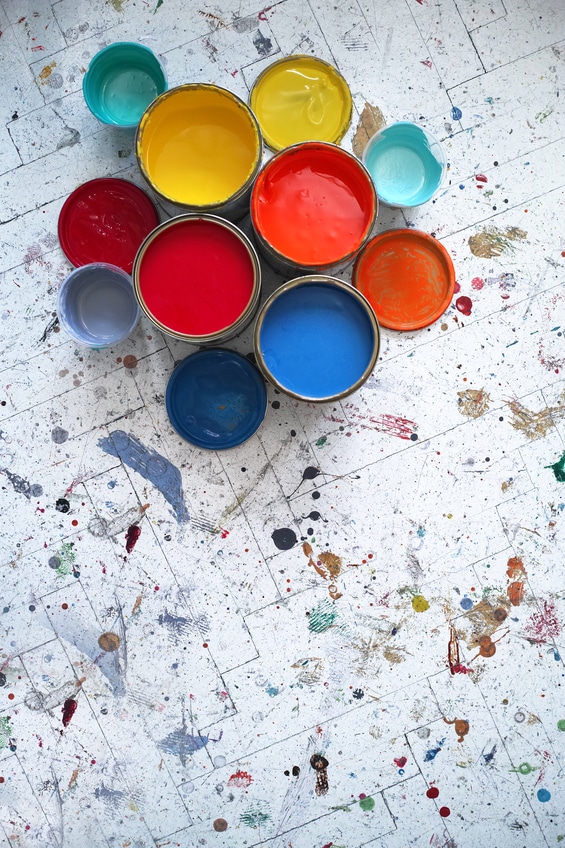 Different Size And Colour Paint Cans With Paint Splashed Floor