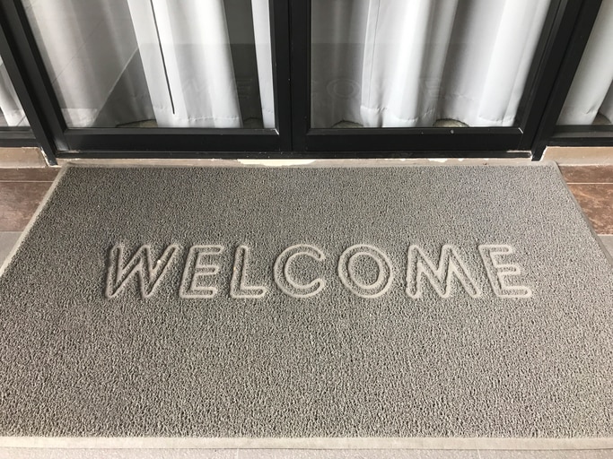 Welcome wording on gray grunge door mat