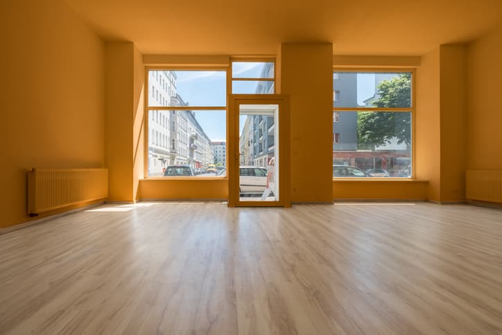 renovated showroom / shop - empty room with wooden floor and shopping window