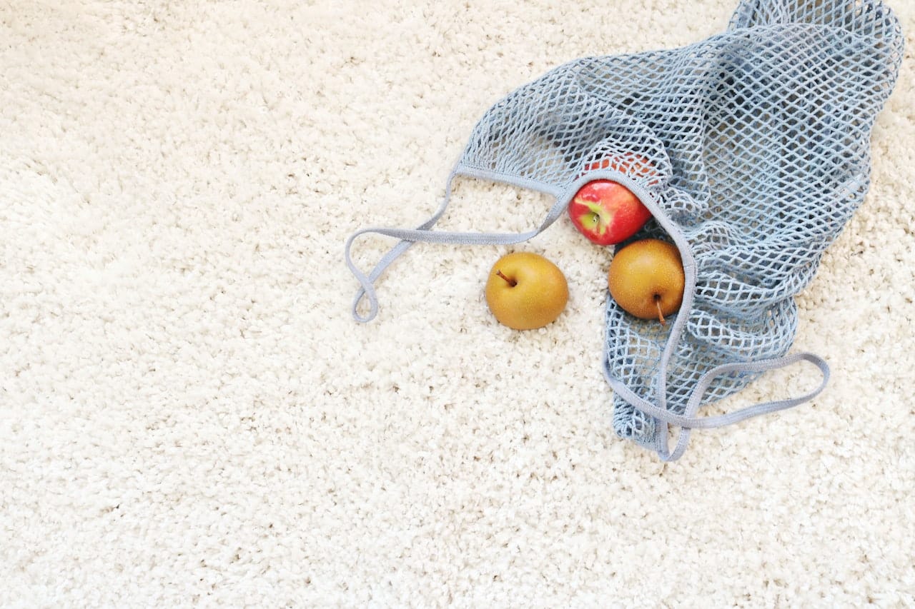 white carpet with fruits in net bag
