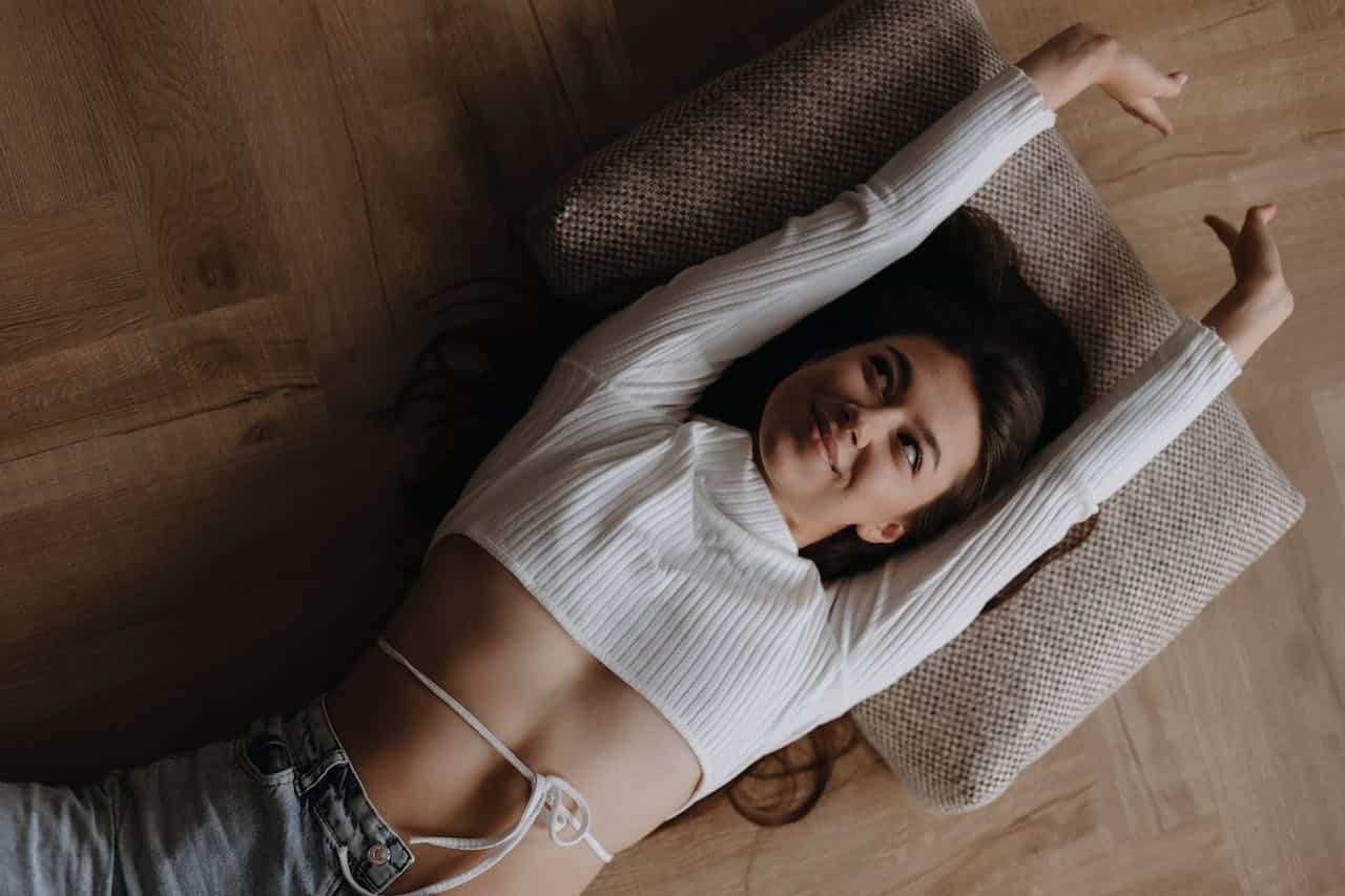 woman laying on wooden floor